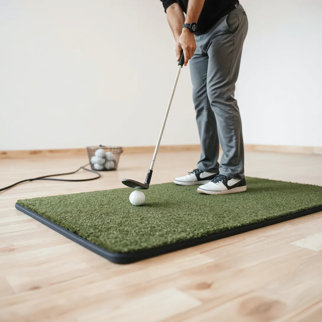 Golf club striking a ball on a quality hitting mat during indoor practice