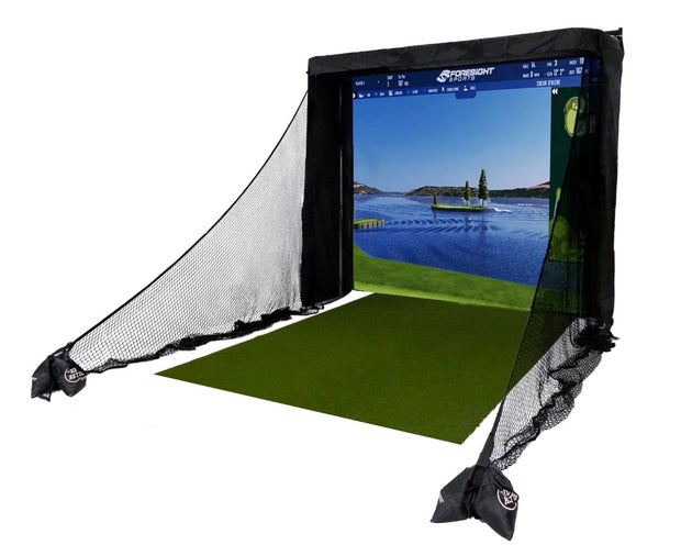 Golf simulator with a projector screen displaying a golf course, surrounded by black netting.