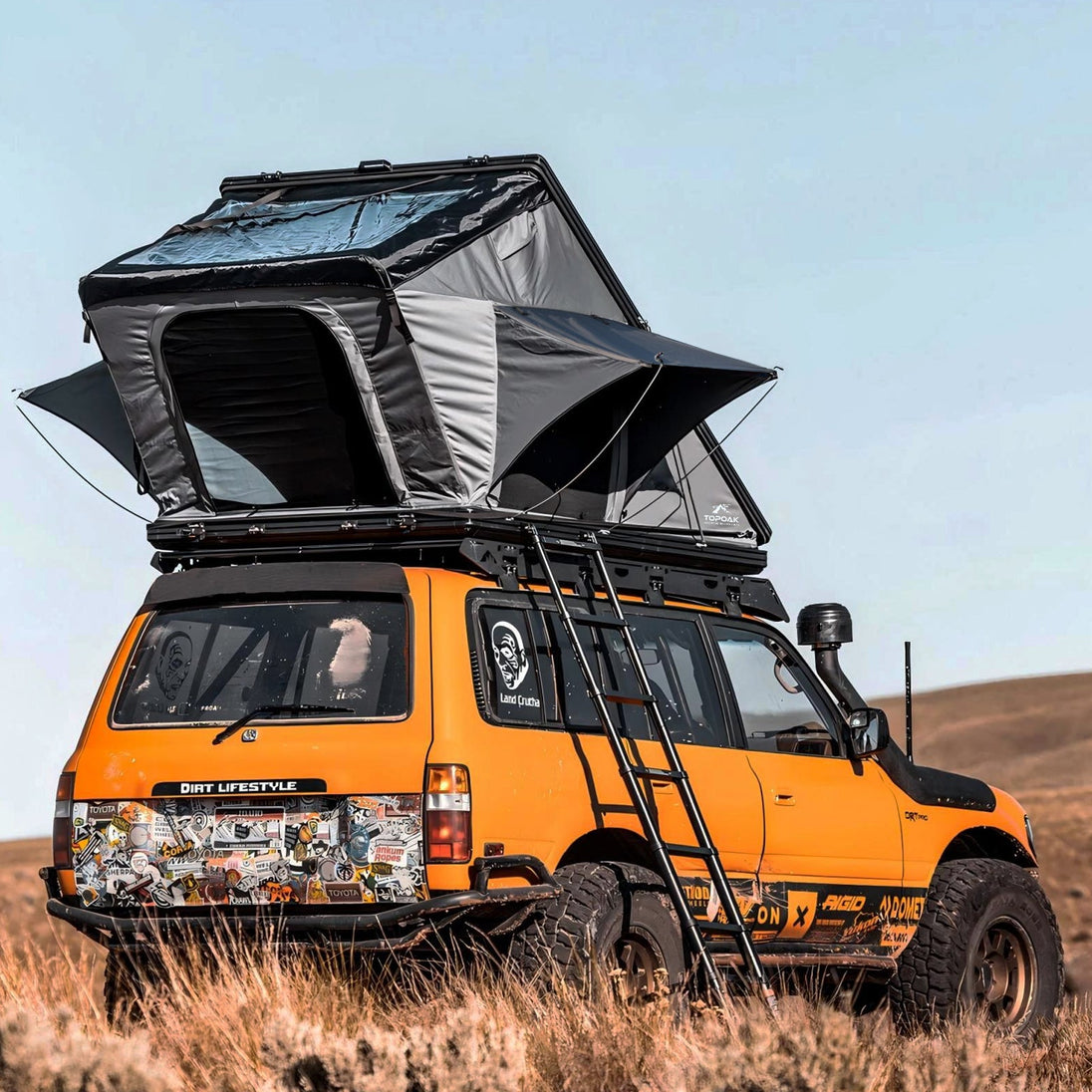 TOPOAK Stellar rooftop tent shown from a rear angle, fully opened on a vehicle for overland camping